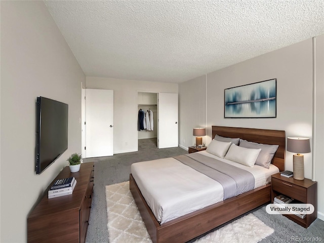 bedroom with carpet flooring, a textured ceiling, and a closet