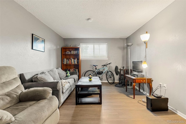 16259 W 10th Ave Unit L2, Golden, CO 80401 - living area featuring light wood-style flooring, a textured ceiling, and a textured wall