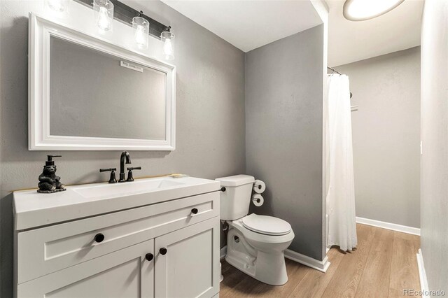 16259 W 10th Ave Unit L2, Golden, CO 80401 - full bathroom with wood finished floors, vanity, and curtained shower