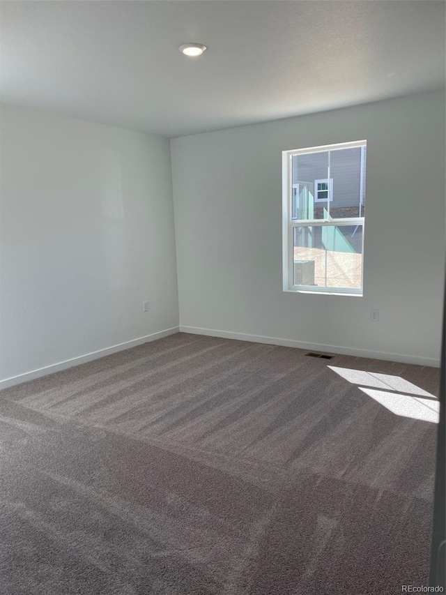 spare room with carpet flooring, baseboards, and recessed lighting