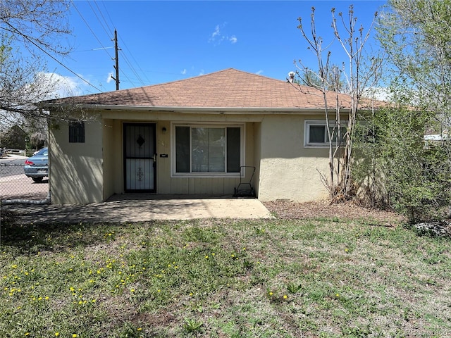 rear view of property featuring a yard