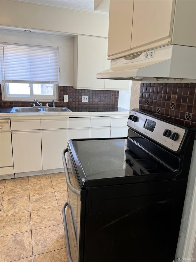 kitchen featuring sink, dishwasher, tasteful backsplash, light tile flooring, and range with electric stovetop