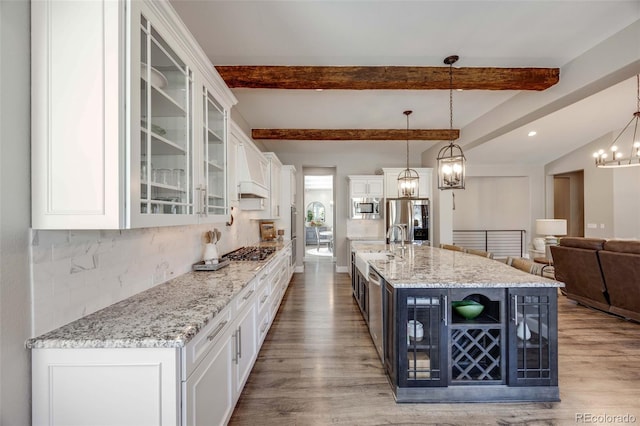 360 Basilwood Way, Highlands Ranch, CO 80126 - kitchen with appliances with stainless steel finishes, white cabinets, a chandelier, wood finished floors, and glass insert cabinets