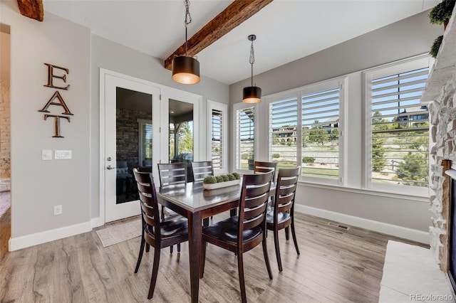 360 Basilwood Way, Highlands Ranch, CO 80126 - dining room featuring beam ceiling, light wood finished floors, and a fireplace