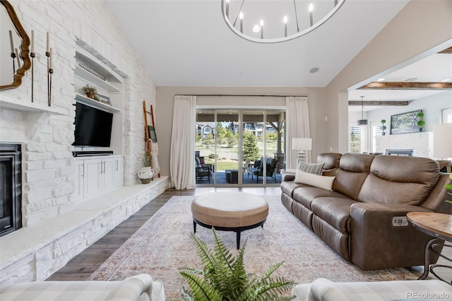 360 Basilwood Way, Highlands Ranch, CO 80126 - living area with a fireplace, lofted ceiling, wood finished floors, and a chandelier