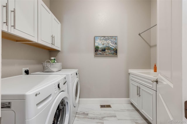 360 Basilwood Way, Highlands Ranch, CO 80126 - laundry room featuring cabinet space, light marble finish floors, and washer and clothes dryer