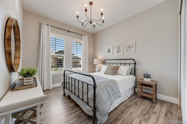 360 Basilwood Way, Highlands Ranch, CO 80126 - bedroom featuring light wood-style flooring and a chandelier