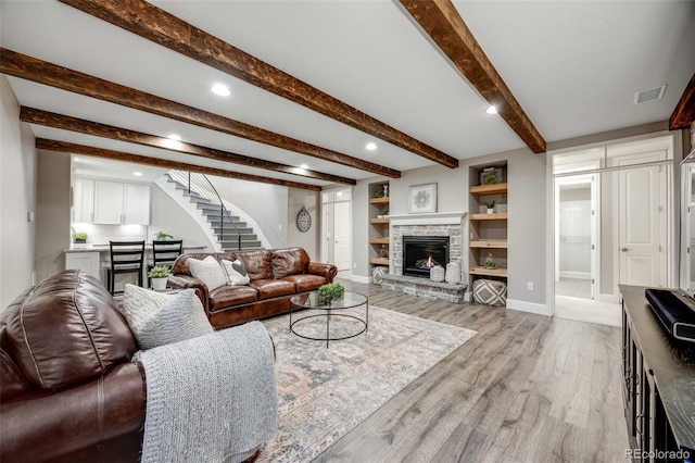360 Basilwood Way, Highlands Ranch, CO 80126 - living area featuring a fireplace, light wood-type flooring, stairs, beam ceiling, and recessed lighting