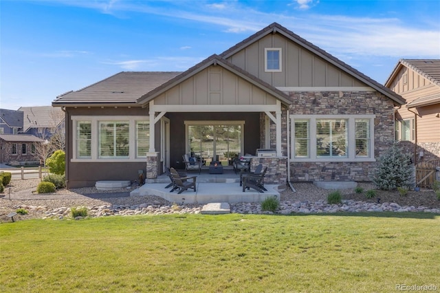 360 Basilwood Way, Highlands Ranch, CO 80126 - back of property with stone siding, a lawn, a patio, and board and batten siding