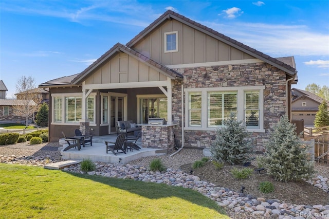 360 Basilwood Way, Highlands Ranch, CO 80126 - rear view of house with exterior kitchen, board and batten siding, a patio, and stone siding