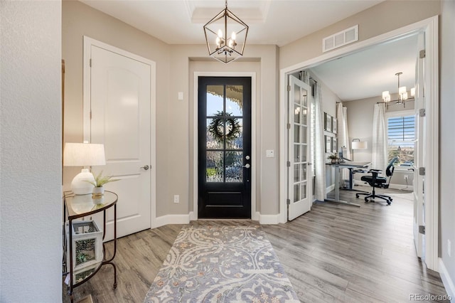 360 Basilwood Way, Highlands Ranch, CO 80126 - foyer entrance with a chandelier, wood finished floors, and french doors