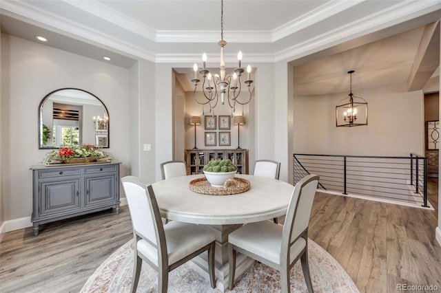 360 Basilwood Way, Highlands Ranch, CO 80126 - dining area featuring a chandelier, light wood finished floors, a raised ceiling, crown molding, and recessed lighting