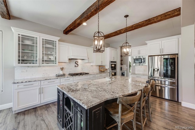 360 Basilwood Way, Highlands Ranch, CO 80126 - kitchen featuring appliances with stainless steel finishes, white cabinets, beam ceiling, wood finished floors, and recessed lighting