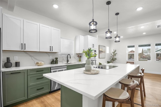 kitchen featuring sink, white cabinetry, black electric cooktop, dishwasher, and a kitchen island