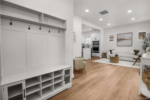 mudroom with light hardwood / wood-style flooring