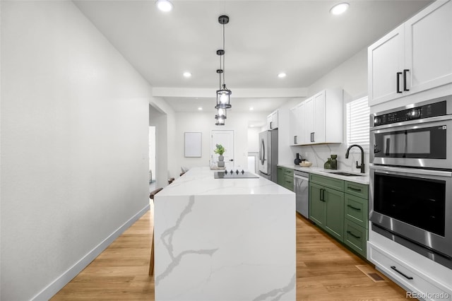 kitchen featuring sink, white cabinetry, green cabinetry, appliances with stainless steel finishes, and a kitchen island