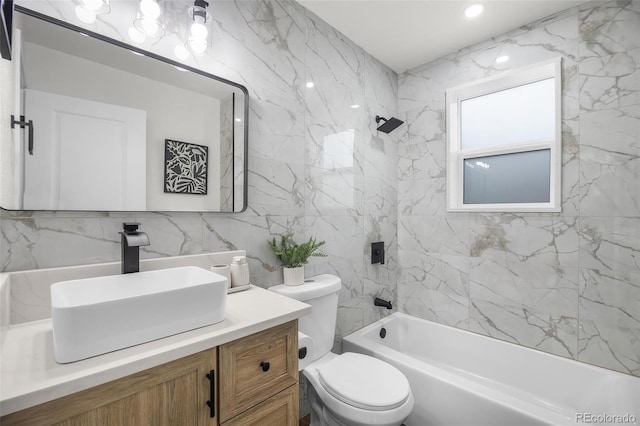 full bathroom featuring tile walls, vanity, decorative backsplash, toilet, and tiled shower / bath