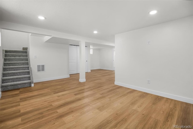 basement with light hardwood / wood-style floors