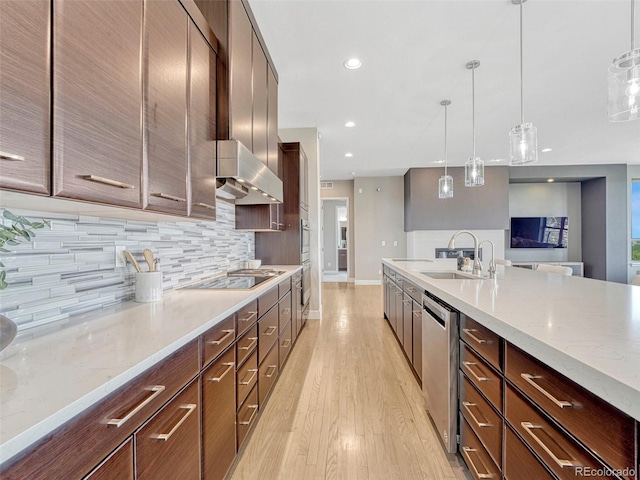 9395 Night Star Pl, Lone Tree, CO 80124 - kitchen featuring wall chimney exhaust hood, appliances with stainless steel finishes, backsplash, recessed lighting, and light wood-style floors