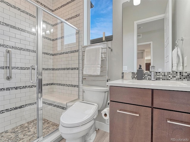 9395 Night Star Pl, Lone Tree, CO 80124 - full bath featuring vanity, a stall shower, wood finished floors, and backsplash
