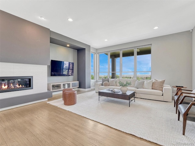 9395 Night Star Pl, Lone Tree, CO 80124 - living area with wood finished floors, recessed lighting, and a glass covered fireplace