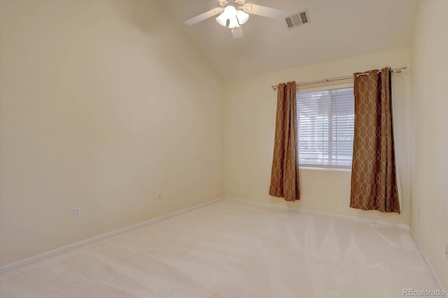 carpeted empty room featuring ceiling fan, visible vents, vaulted ceiling, and baseboards