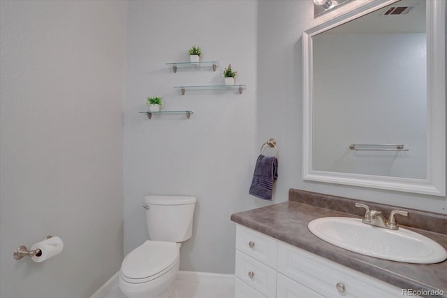 half bathroom featuring visible vents, vanity, and toilet