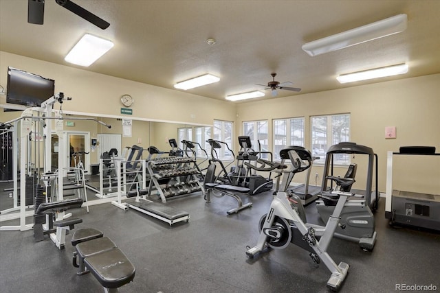 gym featuring a textured ceiling and a ceiling fan