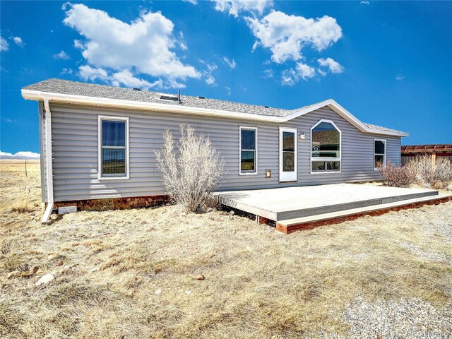 back of house featuring a wooden deck