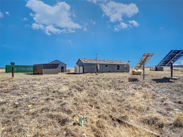 view of yard featuring fence and an outdoor structure