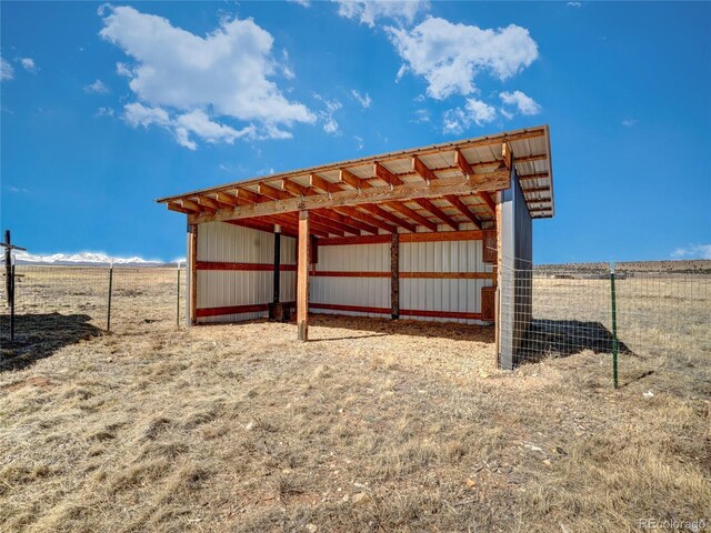 view of pole building with fence