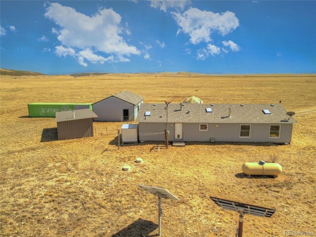 rear view of house featuring a rural view