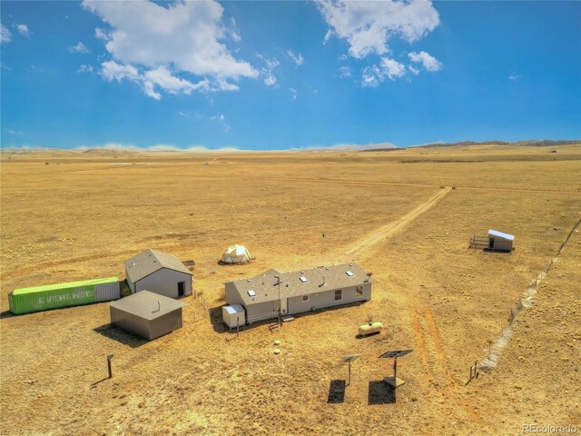 birds eye view of property with a rural view