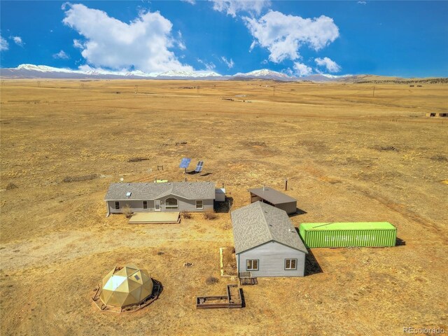 birds eye view of property with a mountain view and a rural view