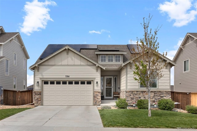 craftsman house with stone siding, concrete driveway, an attached garage, roof mounted solar panels, and board and batten siding
