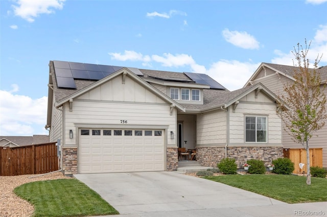 craftsman house featuring stone siding, driveway, a garage, and roof with shingles