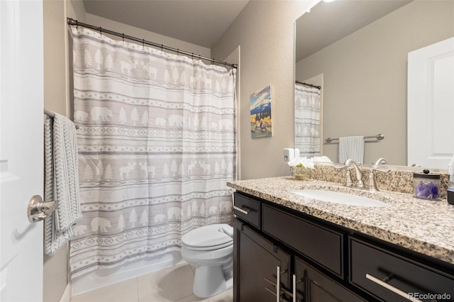 bathroom featuring toilet, vanity, and tile patterned floors