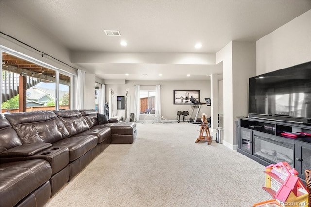 carpeted living room featuring plenty of natural light, recessed lighting, and baseboards