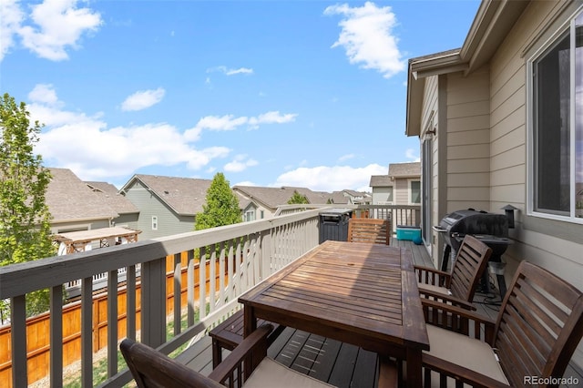 balcony featuring a residential view, outdoor dining space, and grilling area