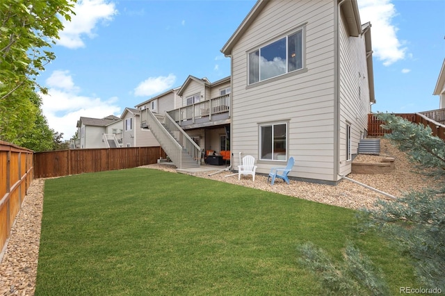 back of house featuring a wooden deck and stairs