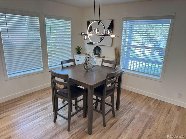 3866 S King St, Denver, CO 80236 - dining area featuring a chandelier, light wood-style floors, and plenty of natural light