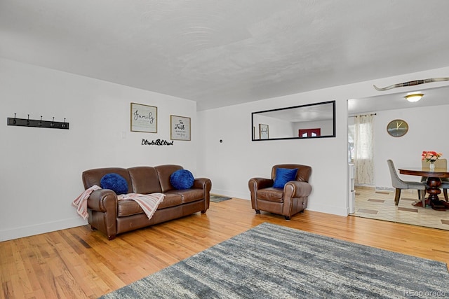 living area with wood finished floors and baseboards