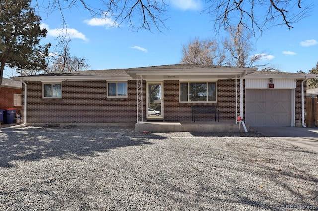 single story home with an attached garage, concrete driveway, and brick siding