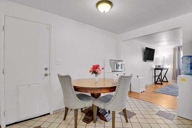 dining area with light tile patterned floors and baseboards