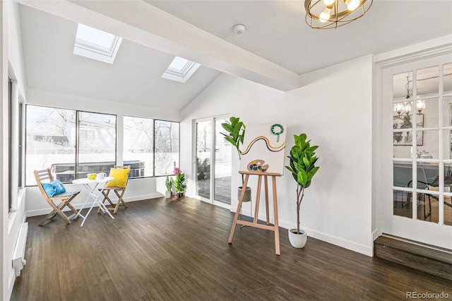 sunroom / solarium with lofted ceiling with skylight and an inviting chandelier