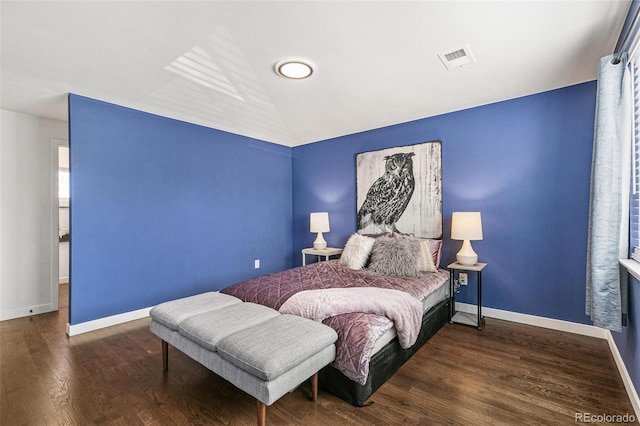 bedroom with dark hardwood / wood-style floors