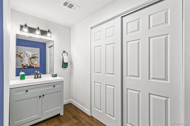 bathroom with hardwood / wood-style flooring and vanity