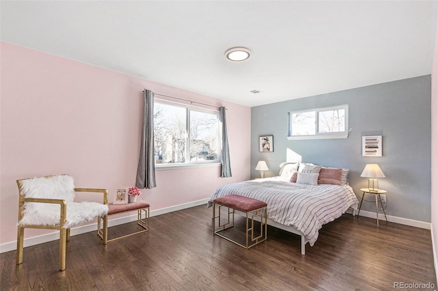 bedroom with dark wood-type flooring and multiple windows