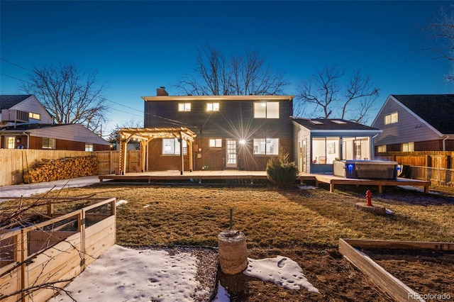 back of house featuring a pergola, a patio area, and a hot tub