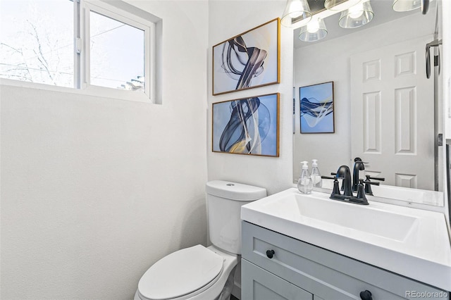 bathroom with toilet and vanity